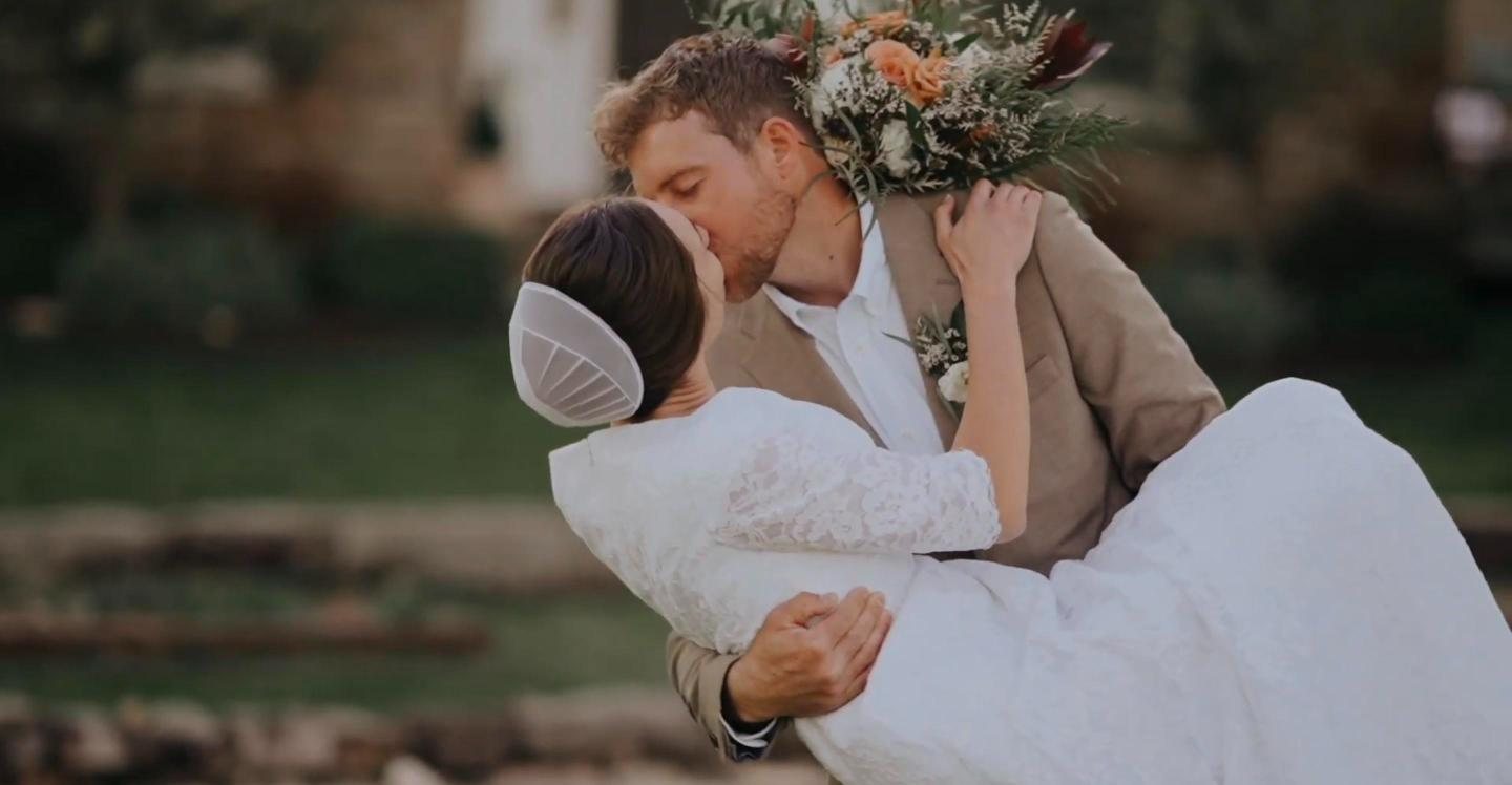 Groom lifting and kissing his bride