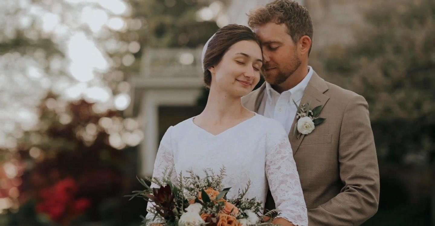 Bride with eyes closed as the groom holds her close