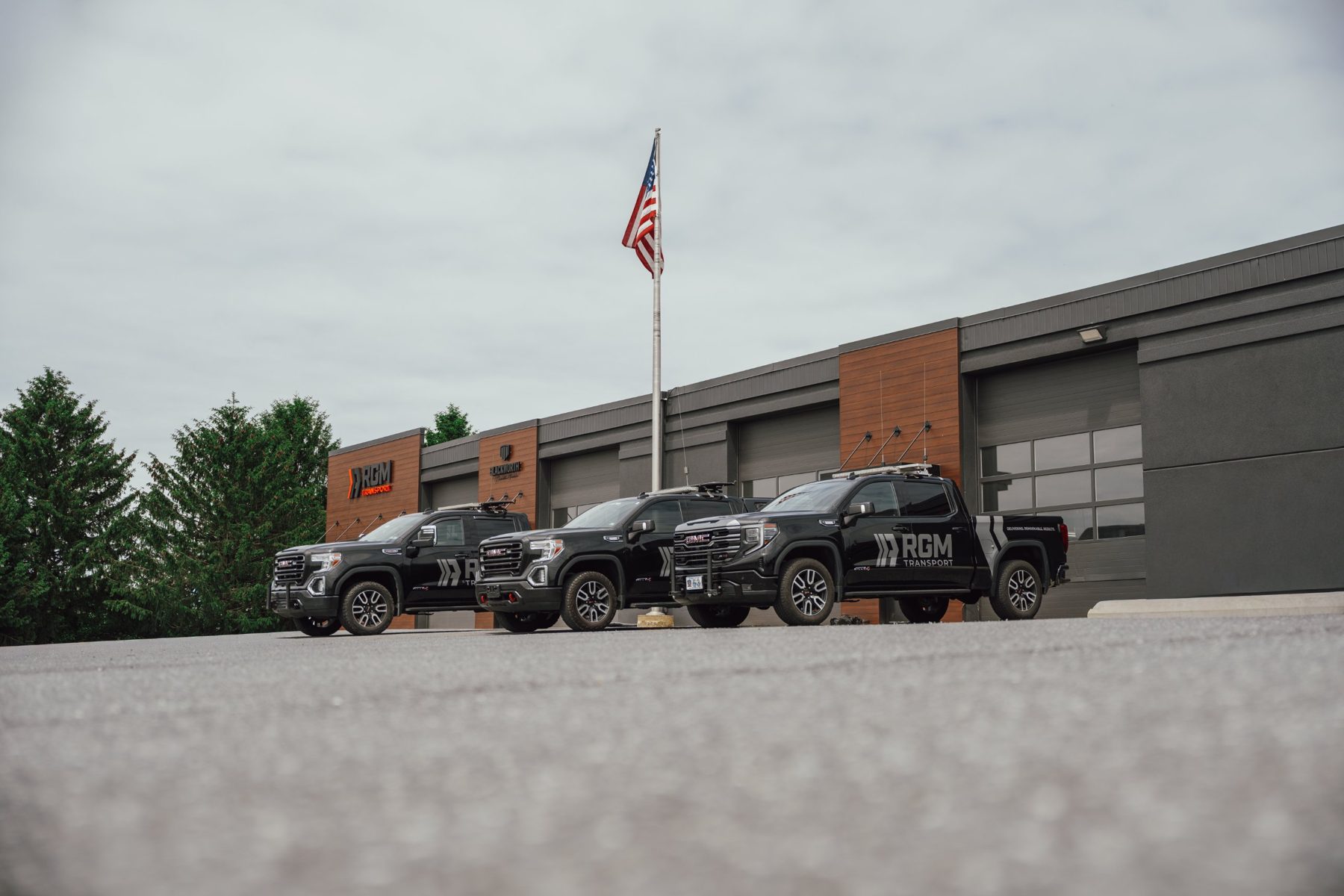 RGM escort trucks parked outside the Bethel shop
